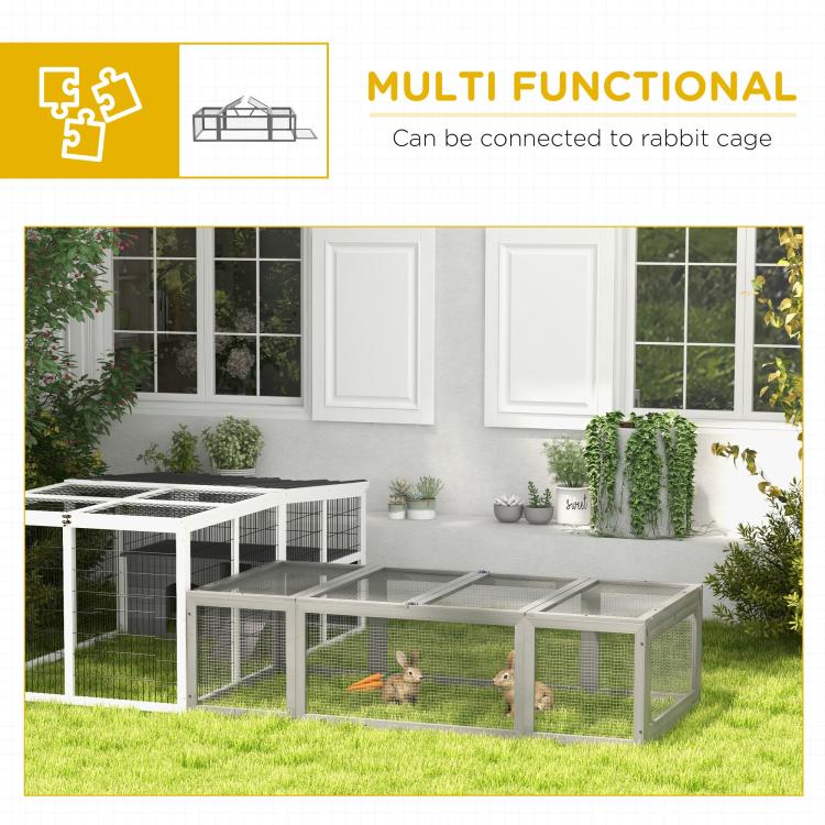 Outdoor gray rabbit hutch with wire-mesh walls, rabbits inside, adjacent fenced run