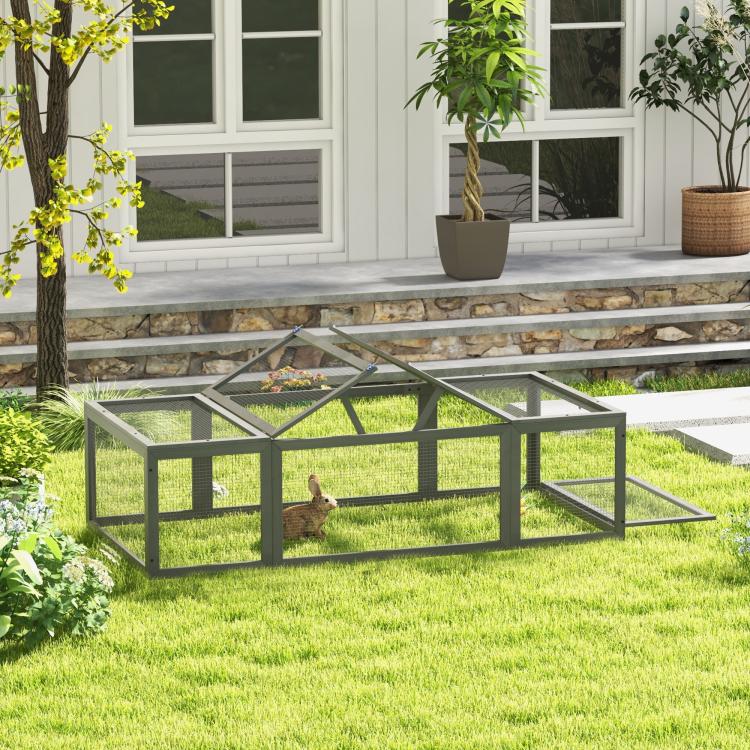 Outdoor gray rabbit hutch with wire-mesh enclosure and open run, rabbit inside