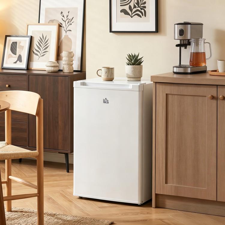 White upright freezer with closed door in a kitchen setting