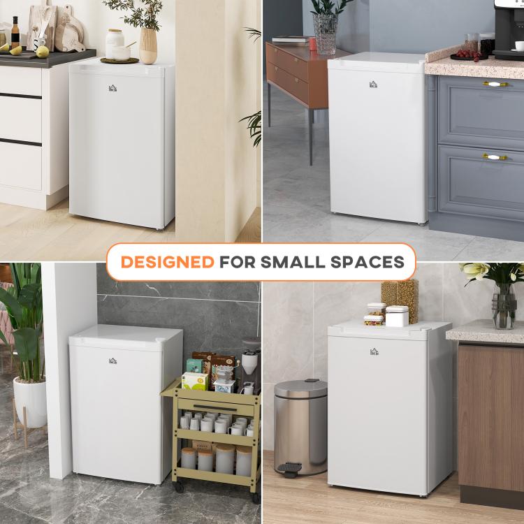White upright freezer placed in a room for compact spaces, front door closed