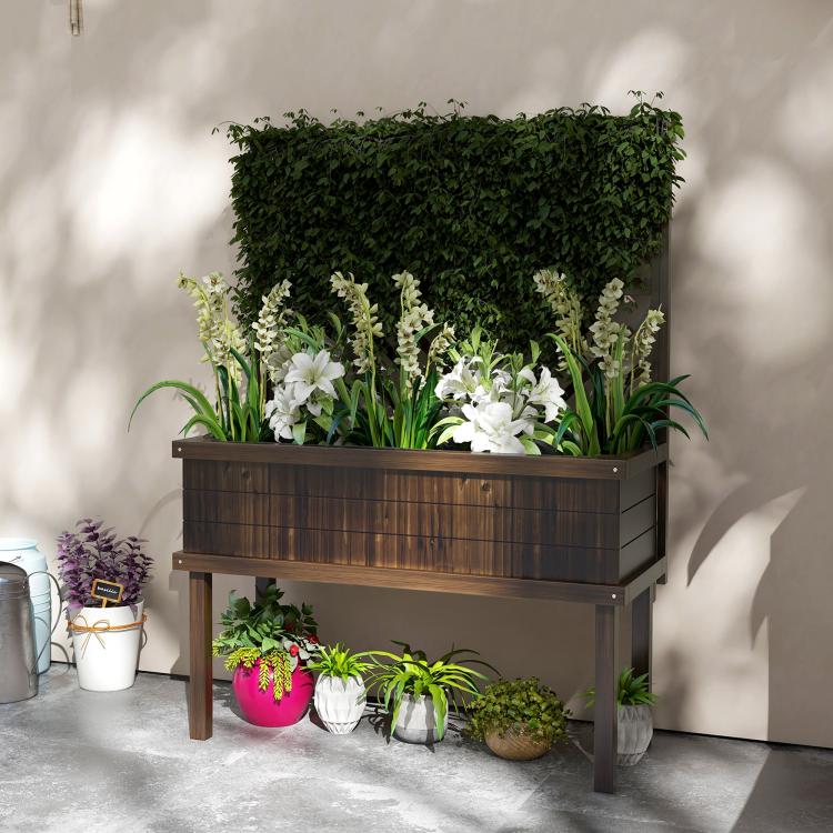 Dark wood elevated garden planter with trellis, filled with white flowers and greens