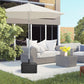 Black outdoor umbrella base table under shade with wood-look surface and storage drawer