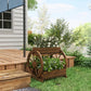 Wooden wagon planter box with wheel front, placed on grass near raised garden beds