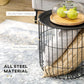 Black wire basket coffee table with round top, shown with small items on a wooden tray