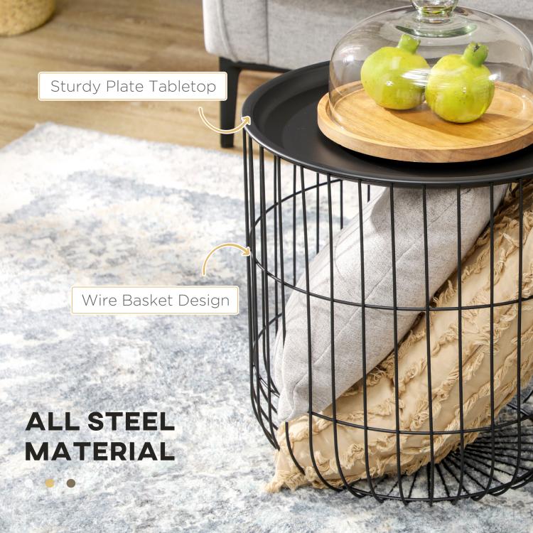Black wire basket coffee table with round top, shown with small items on a wooden tray