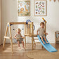 Indoor view of wooden swing set with blue slide and hanging rope swings