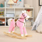 Pink plush rocking horse ride-on with wooden rock base and brown saddle harness details