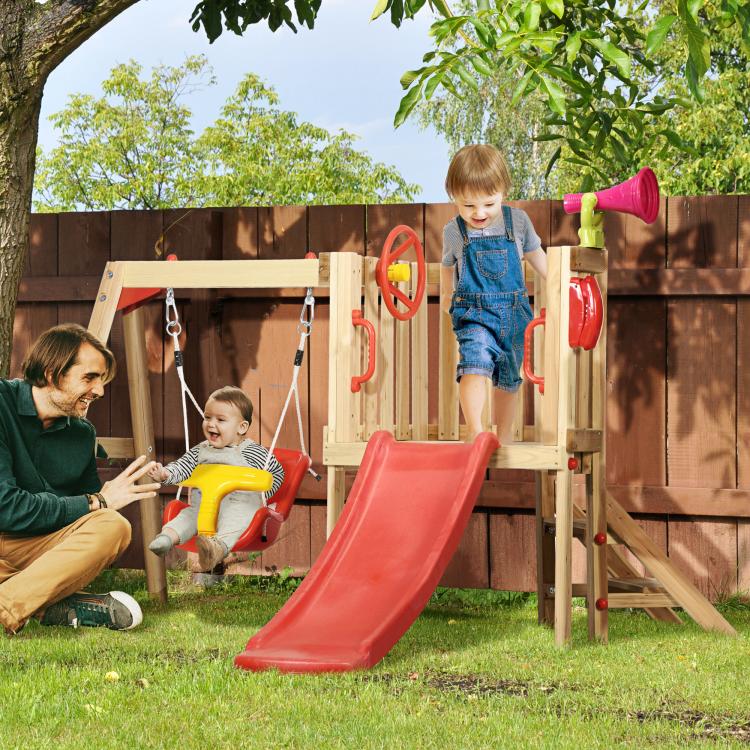 Children playing on a wooden play set with red slide and yellow swing seats