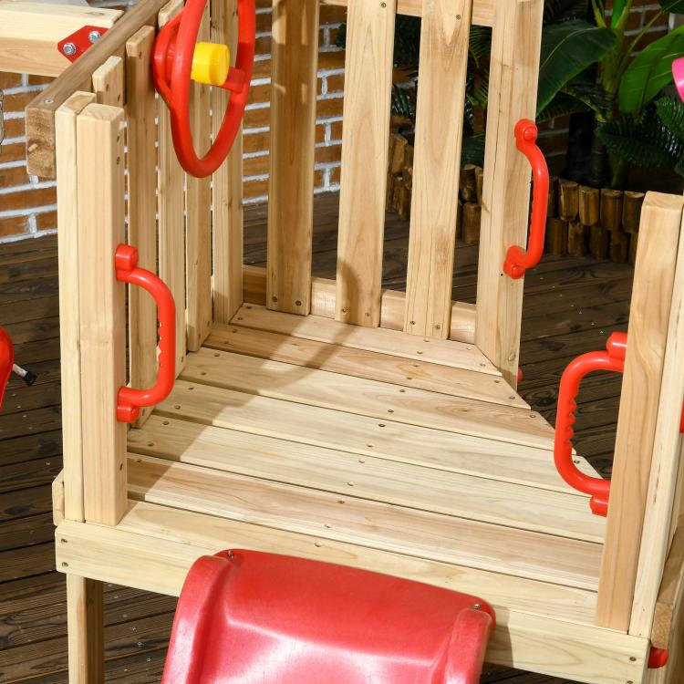 Wooden platform of play set with red slide chute and red safety handles