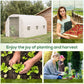 White tunnel greenhouse on grass with roll-up door and window openings