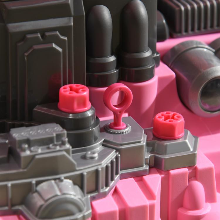 Toy engine close-up with pink and gray parts and small red knobs