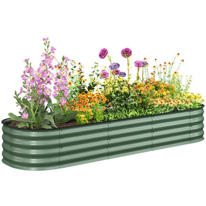 Green metal raised garden bed planter with safety edging, filled with colorful flowers
