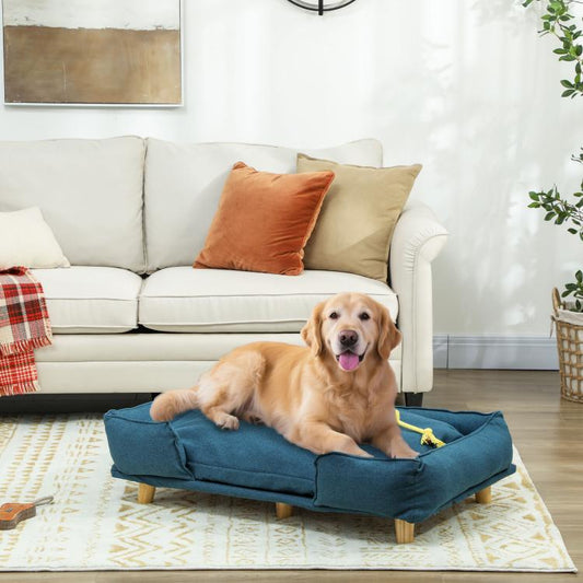 Dark blue raised dog couch bed with thick cushion and wooden feet