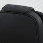 Black cushioned office chair backrest with stitched edges and rounded headrest