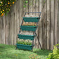 Green 4-tier raised garden planter on black stand with assorted blooming plants