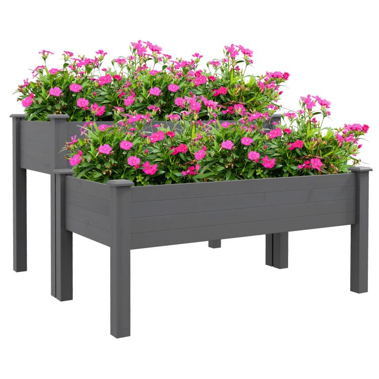 Gray two-tier raised garden bed planter with blooming pink flowers on sturdy legs