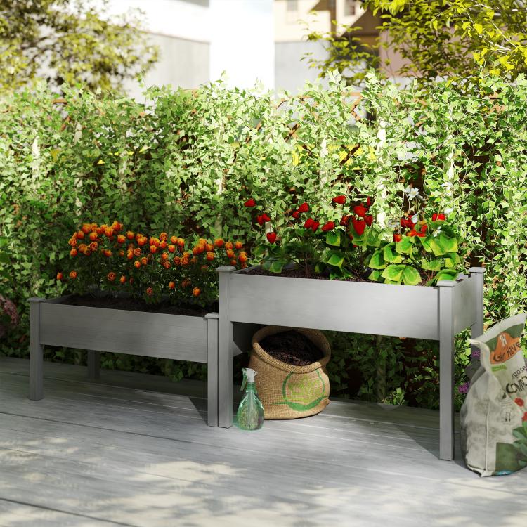 Gray two-tier raised garden bed planter with rows of colorful garden vegetables and herbs