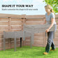 Gray two-tier raised garden bed planter positioned outdoors against a fence