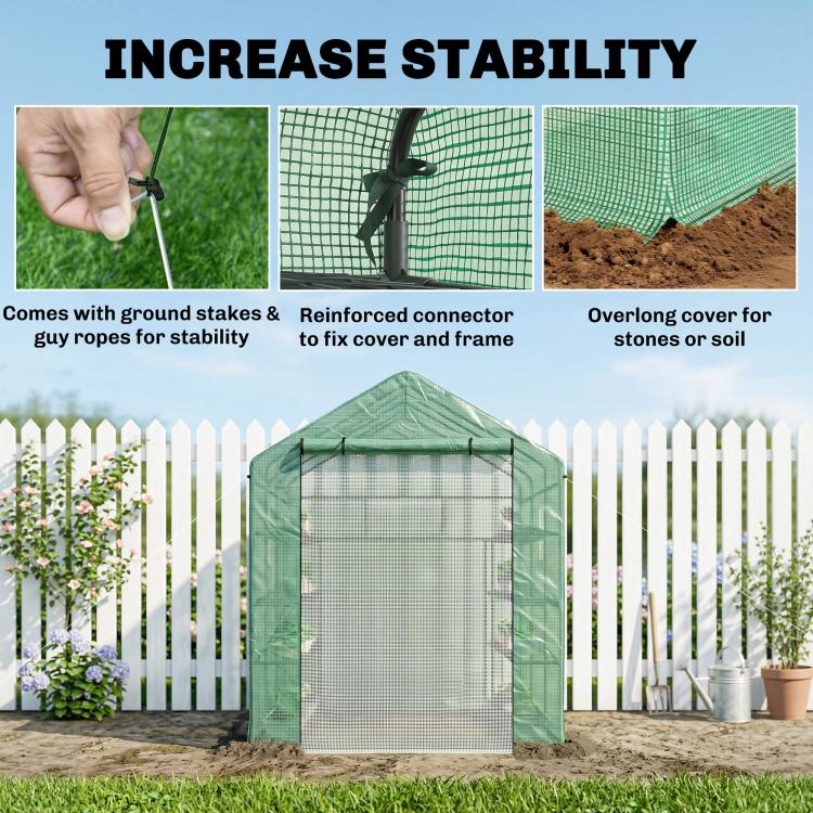 Green mesh greenhouse with ground stakes and ropes for added stability