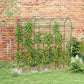 Green metal arch trellis with wire mesh supporting climbing vines along a brick wall