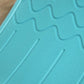 Close-up of turquoise-blue textured grip pattern on the balance board surface