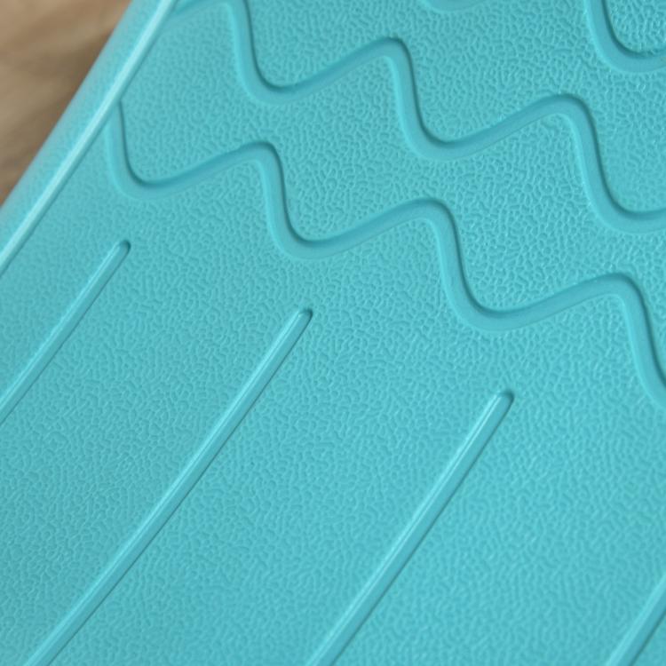 Close-up of turquoise-blue textured grip pattern on the balance board surface