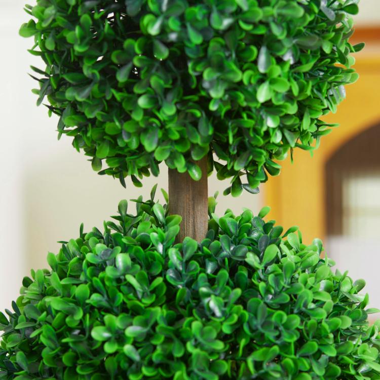 Artificial boxwood topiary trunk with layered green ball foliage, black pot partially visible
