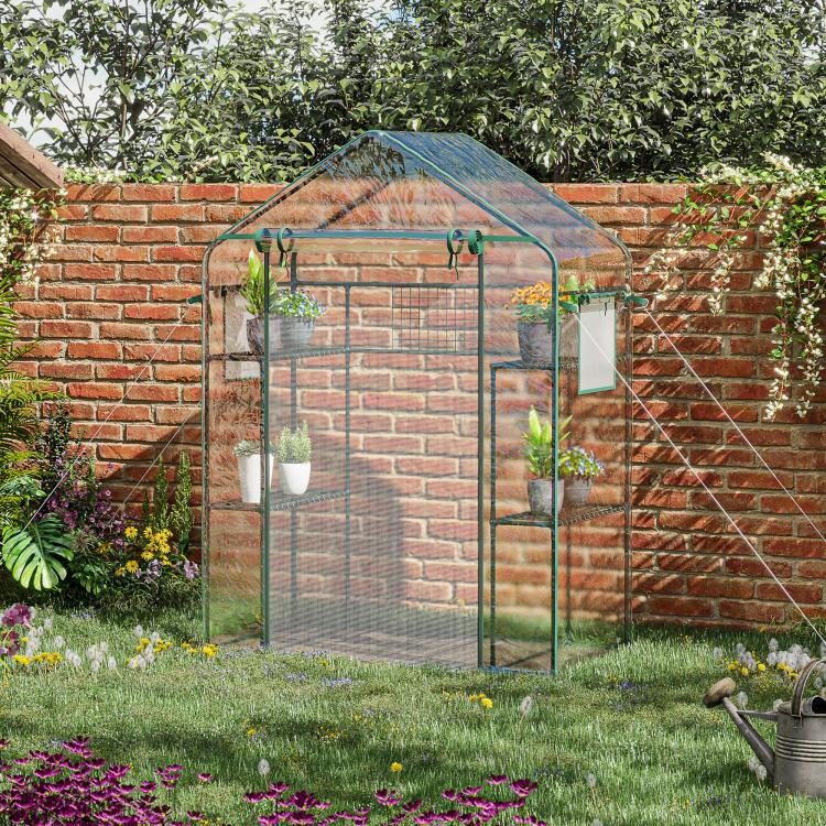 Outdoor walk-in mini greenhouse with green frame, mesh panels, and clear top cover