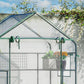 Outdoor walk-in mini greenhouse close-up of green frame, mesh door, and clear cover