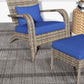 Wicker adirondack chair with blue seat/back cushions and matching ottoman, side view