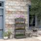 Gray 4-tier vertical planter with flower boxes on an outdoor patio