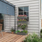 Gray 4-tier vertical wooden planter with potted flowers along the side