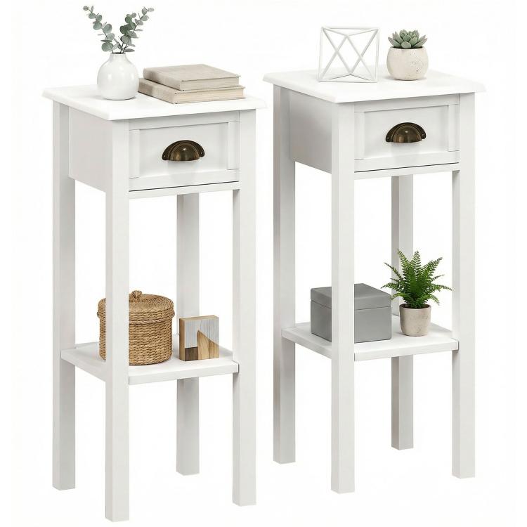 Set of 2 white 2-tier side tables with drawer and open shelf, round brass-toned pulls.