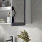 Wall-mounted medicine cabinet with dark gray mirrored doors and white frame