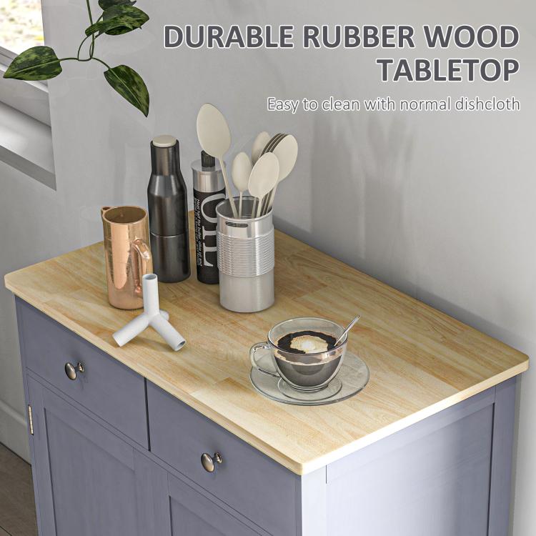 Gray cabinet with light wood countertop and two drawers; shown with tableware on top.