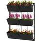 Black 3-tier wall-mounted planter with six rectangular pots, filled with flowers
