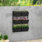 Black 3-tier wall planter with six rectangular pots for a flower wall display