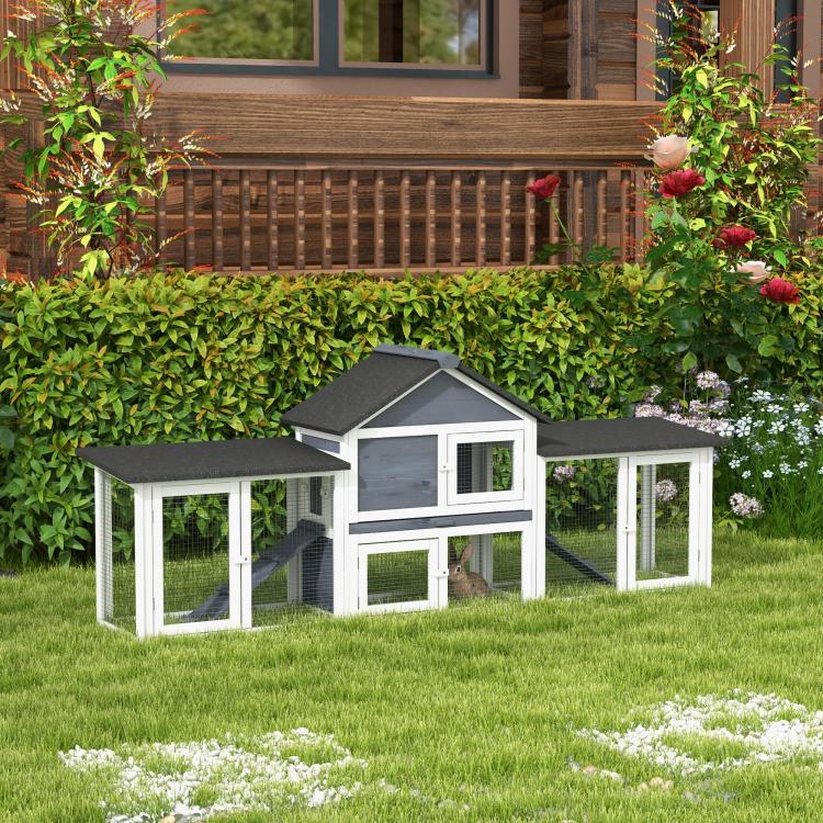 Outdoor two-story rabbit hutch in dark gray and white with enclosed side run