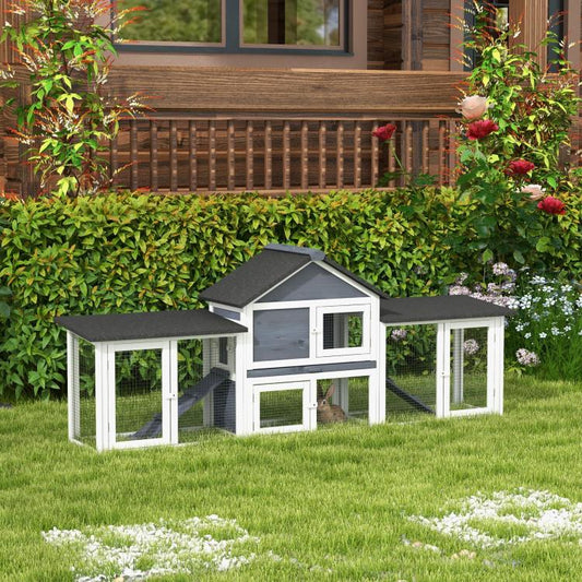 Outdoor two-story rabbit hutch in dark gray and white with enclosed side run