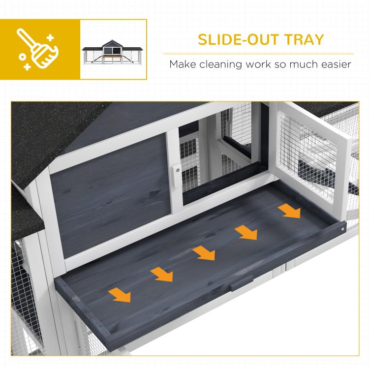 Slide-out tray inside a two-story rabbit hutch with dark gray floor panel
