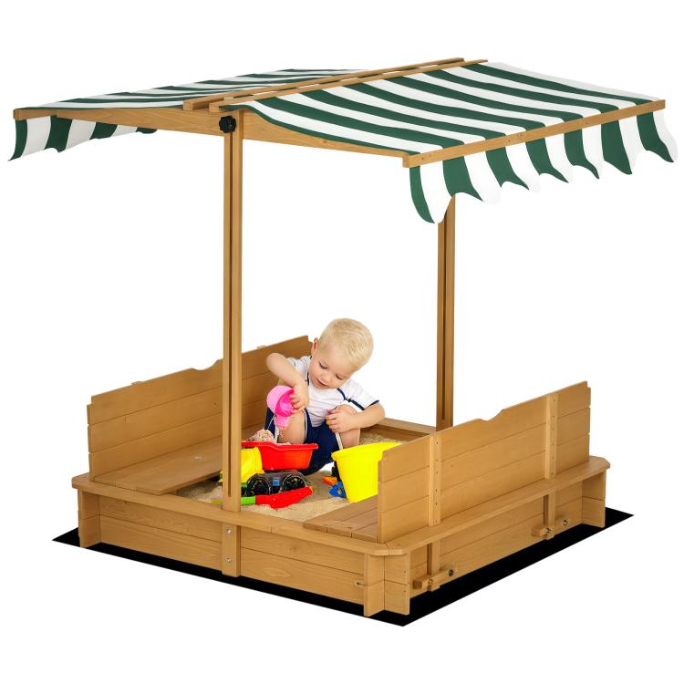 Kids wooden sandbox with striped canopy and bench seats, child playing inside