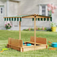 Kids wooden sandbox with striped canopy and bench seats on grass, open side view