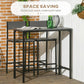 Gray counter-height bar table with two stools tucked beneath for space saving.