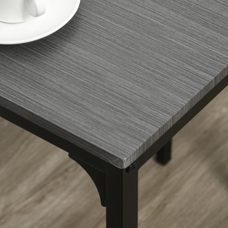 Close-up of gray tabletop corner with dark metal edge and rounded protective detail.