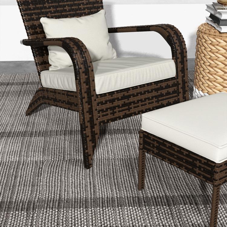 Wicker Adirondack fire pit chair with white cushions and matching ottoman