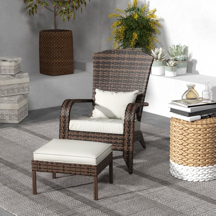 Brown wicker chair with white cushion seat and ottoman beside outdoor side table