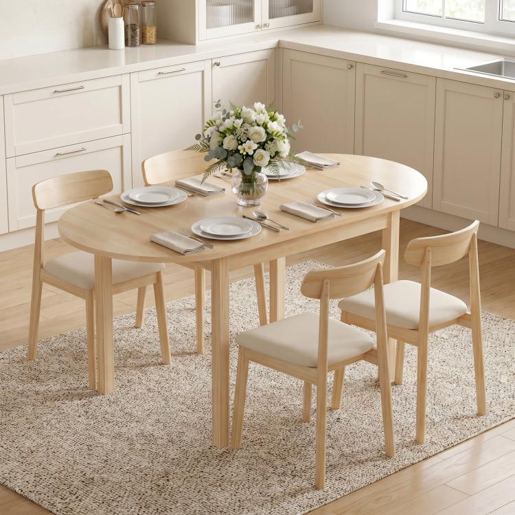 Natural wood drop-leaf dining table in a bright kitchen, with matching chairs