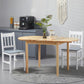 Natural wood drop-leaf dining table with two white chairs in a modern kitchen