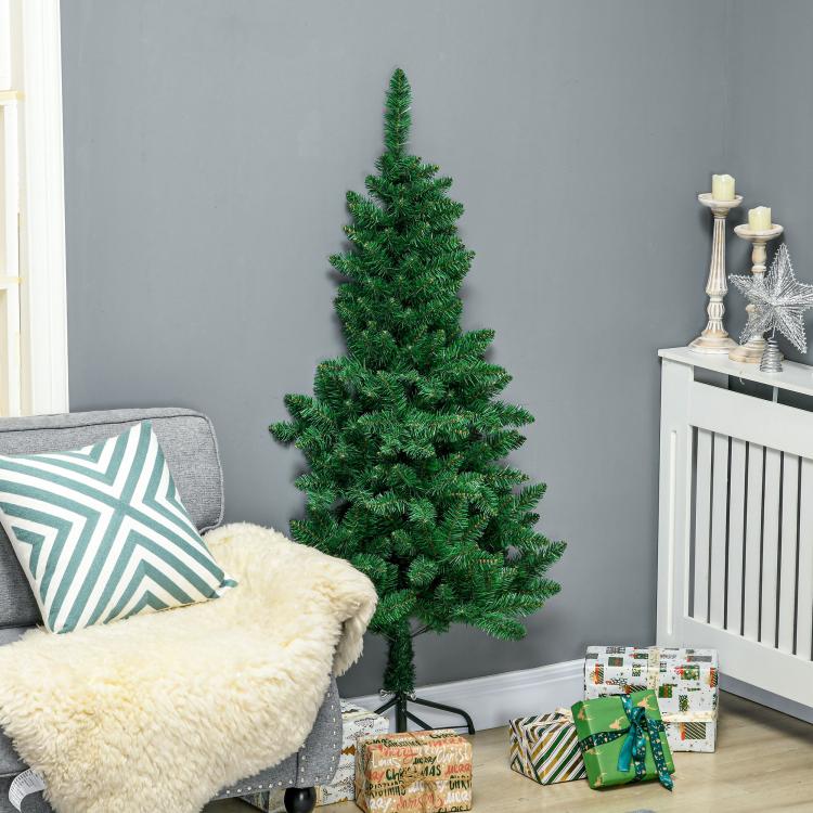 Artificial half Christmas tree with dense green foliage on base in living room