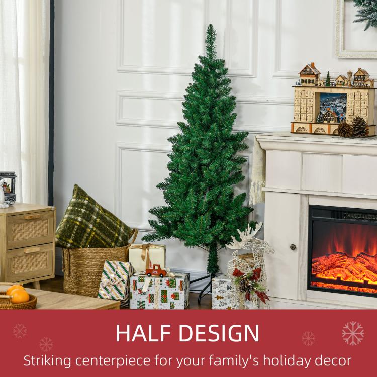 Artificial half Christmas tree with holiday decorations beside fireplace mantle
